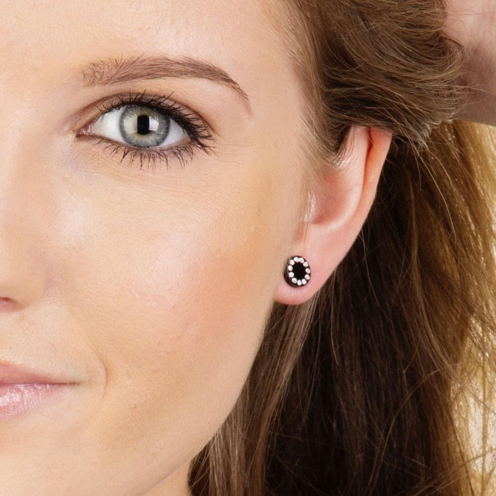 Half face of female model with hypoallergenic earrings
