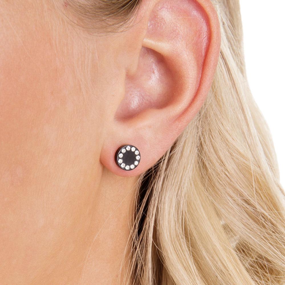 Female model ear close up with titanium puck swarovski earrings