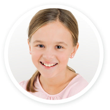 Girl smiling radiantly with her freshly pierced ears